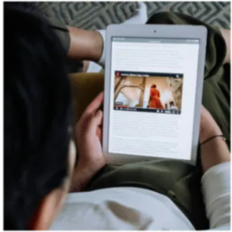 Person Reading a Tablet